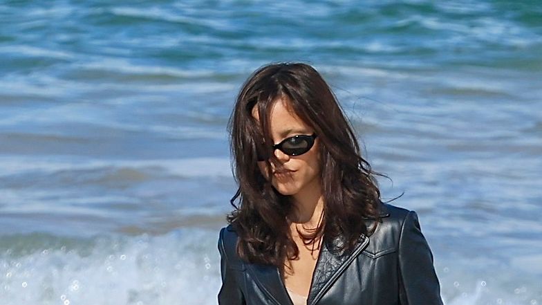 Beach Goth Reimagined: Jenna Ortega's Leather Trench And Boots Look